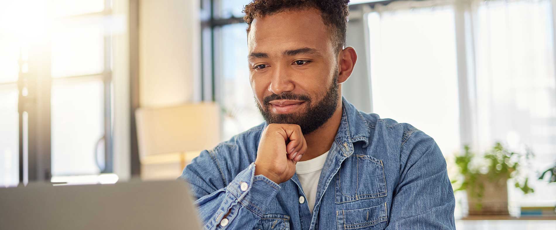 black man looking at computer